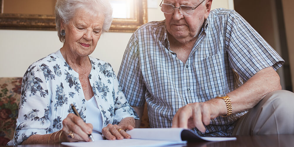 An elderly couple drafting a will