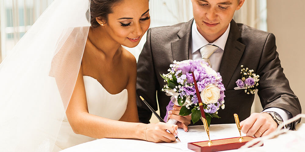 bride & groom signing marriage license